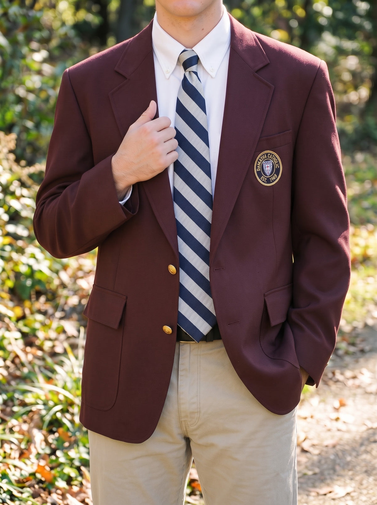 Student wearing the maroon DeMatha blazer with a striped tie