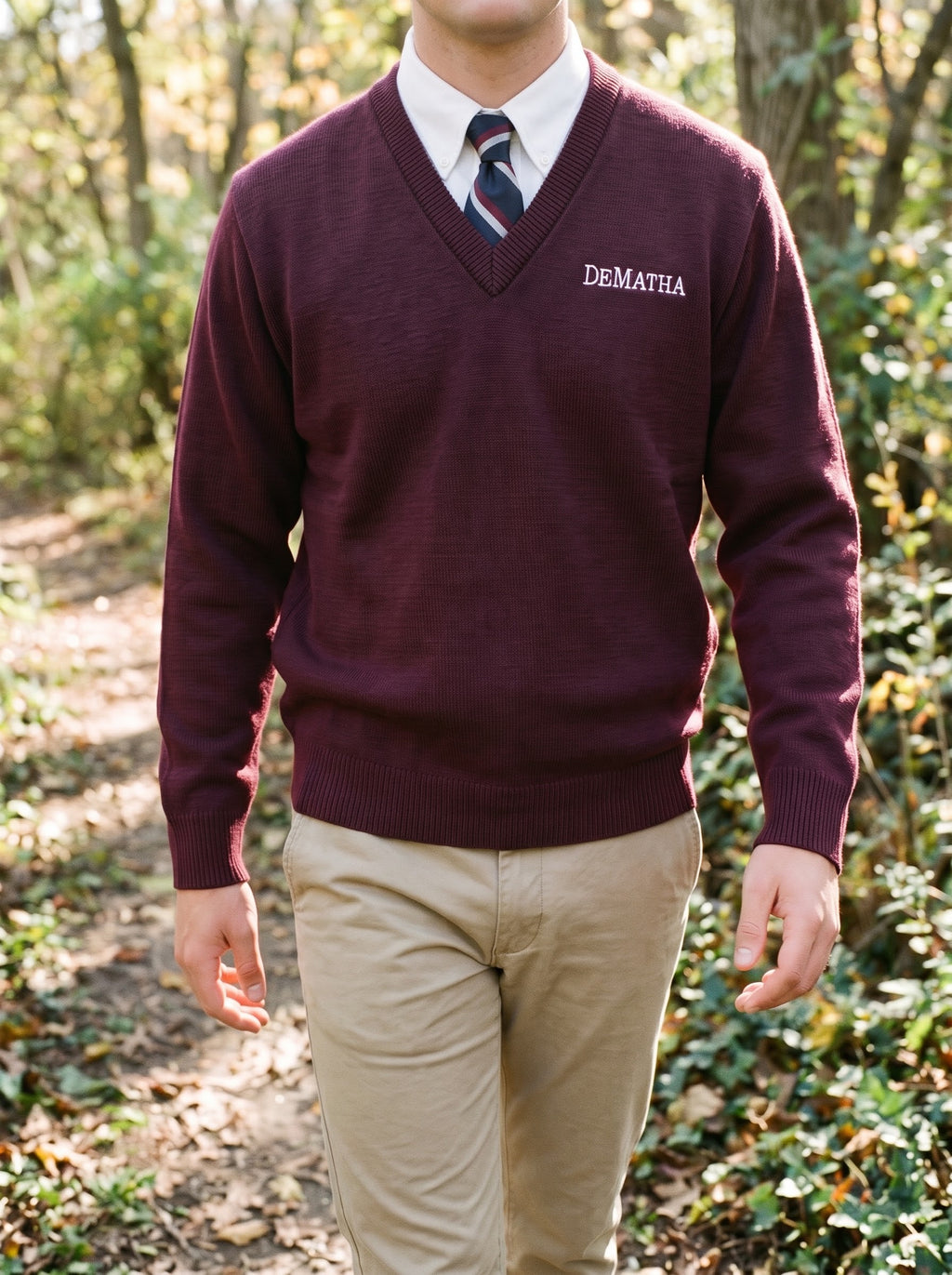 Student wearing the maroon DeMatha V-neck sweater over an oxford and tie