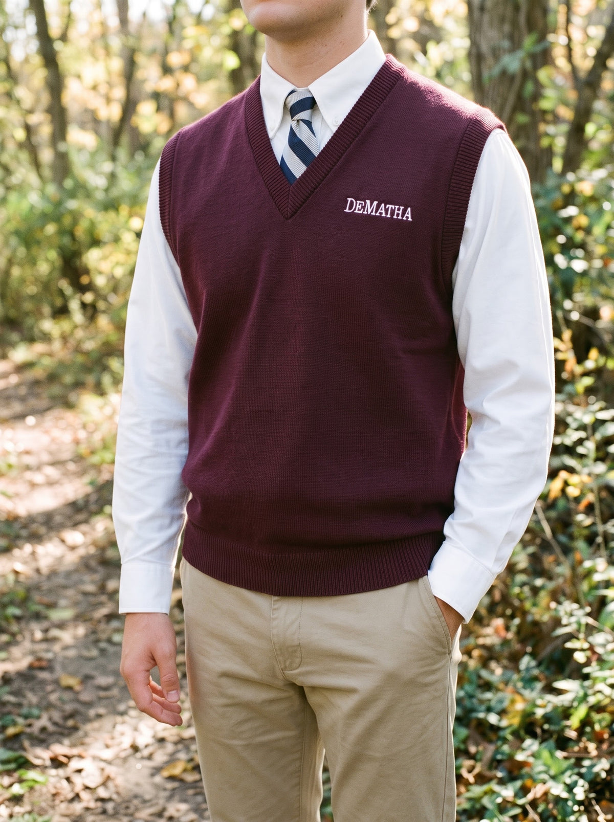 Student wearing the maroon DeMatha sweater vest over a white oxford and tie