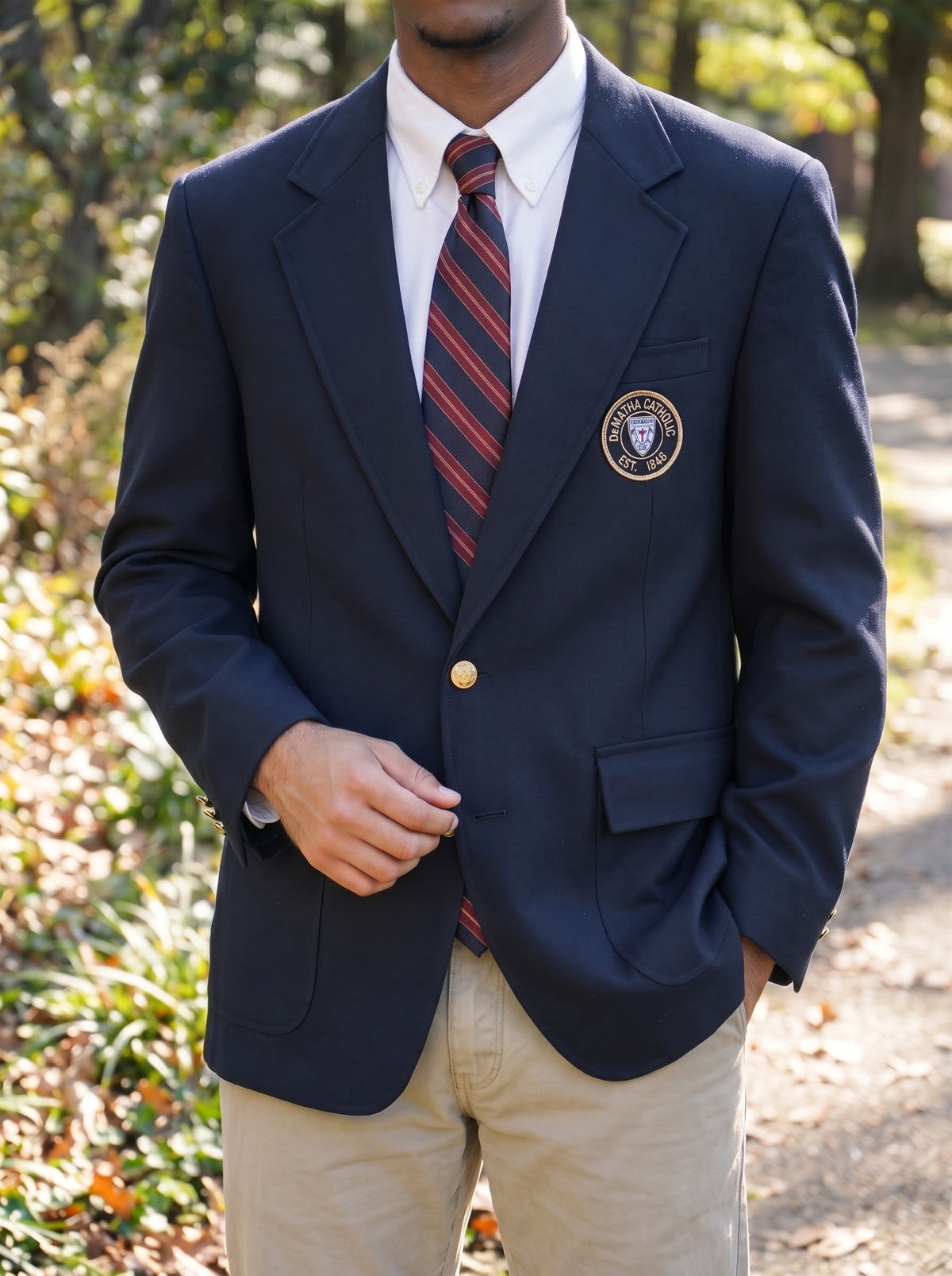 Student wearing the navy DeMatha blazer with a striped tie
