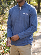 Load image into Gallery viewer, Student wearing the navy DeMatha quarter zip outdoors