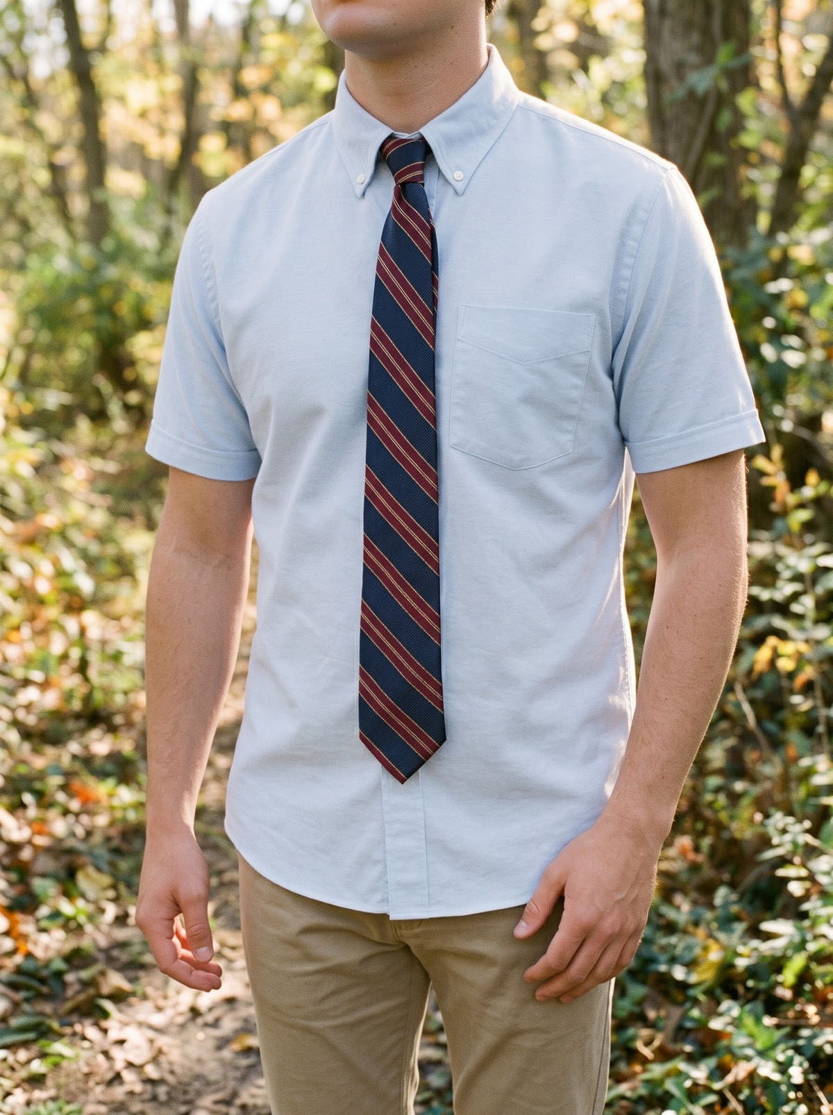 Student wearing the blue short sleeve oxford with a striped tie