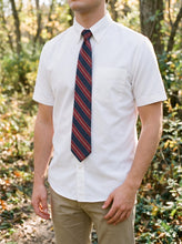 Load image into Gallery viewer, Student wearing the white short sleeve oxford with a striped tie