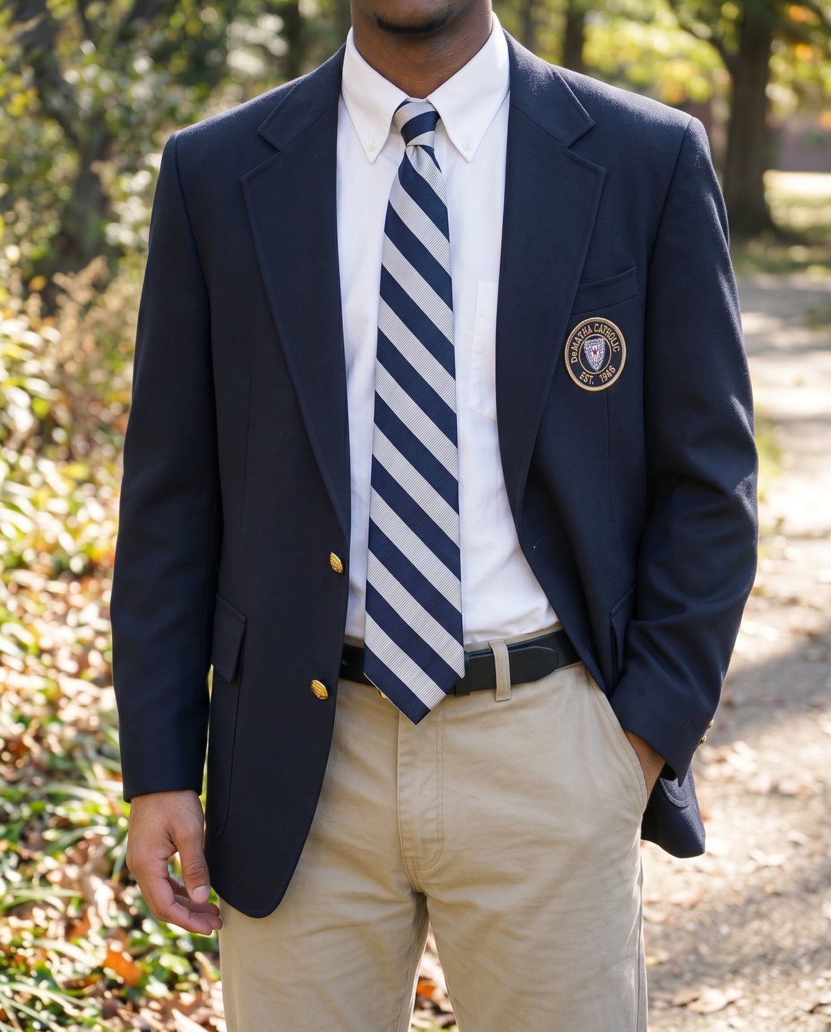 Student wearing the navy and silver striped tie with a navy blazer