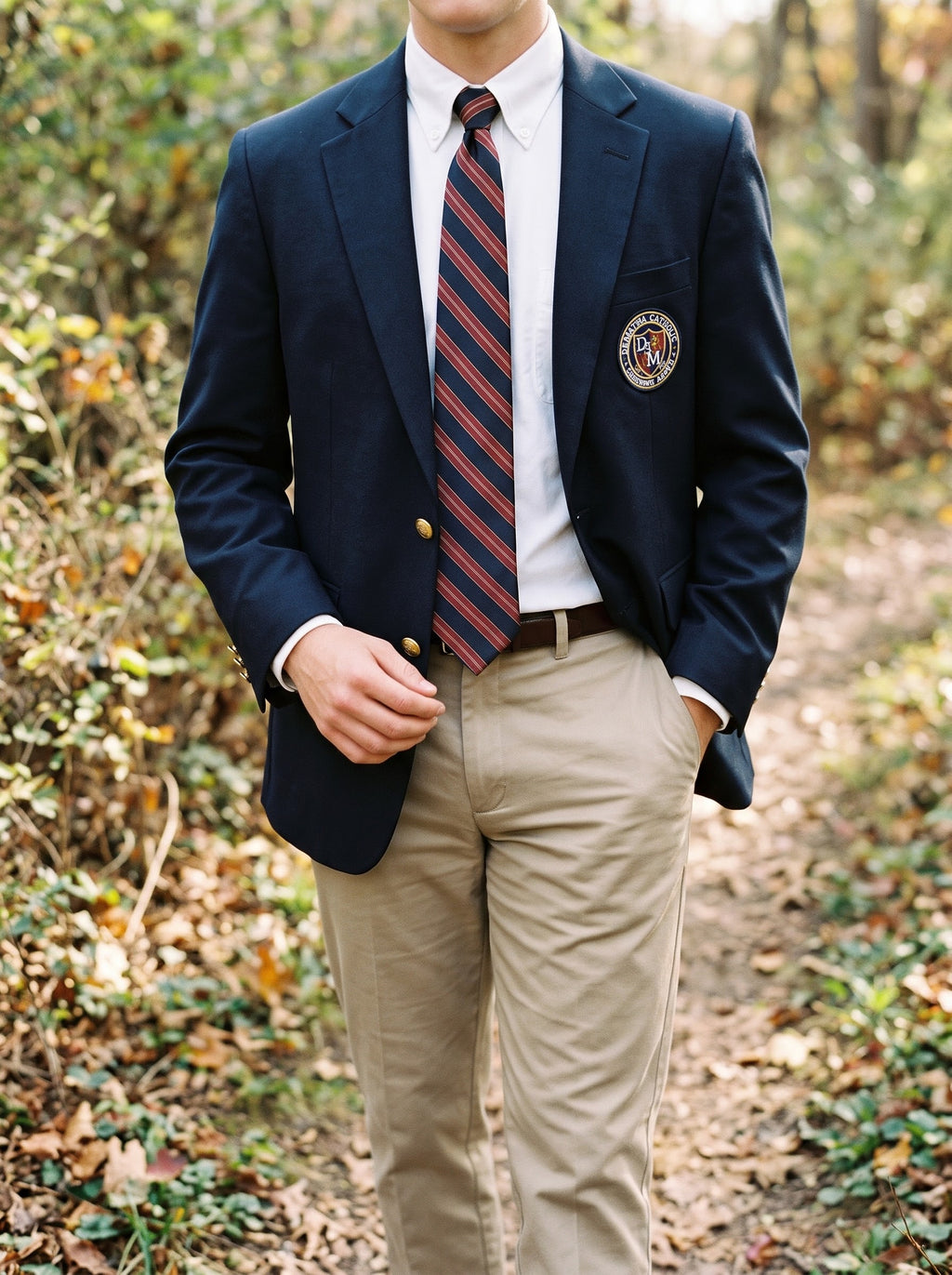 Student wearing the navy, tan and burgundy striped tie with a navy blazer